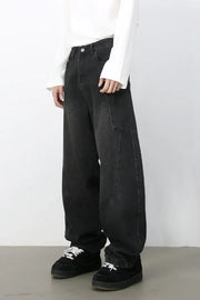 Black denim baggy trousers with a unique seam detail and a relaxed fit.