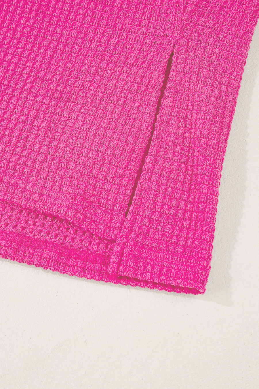 Hot pink waffle knit v-neck top with slit hem detail