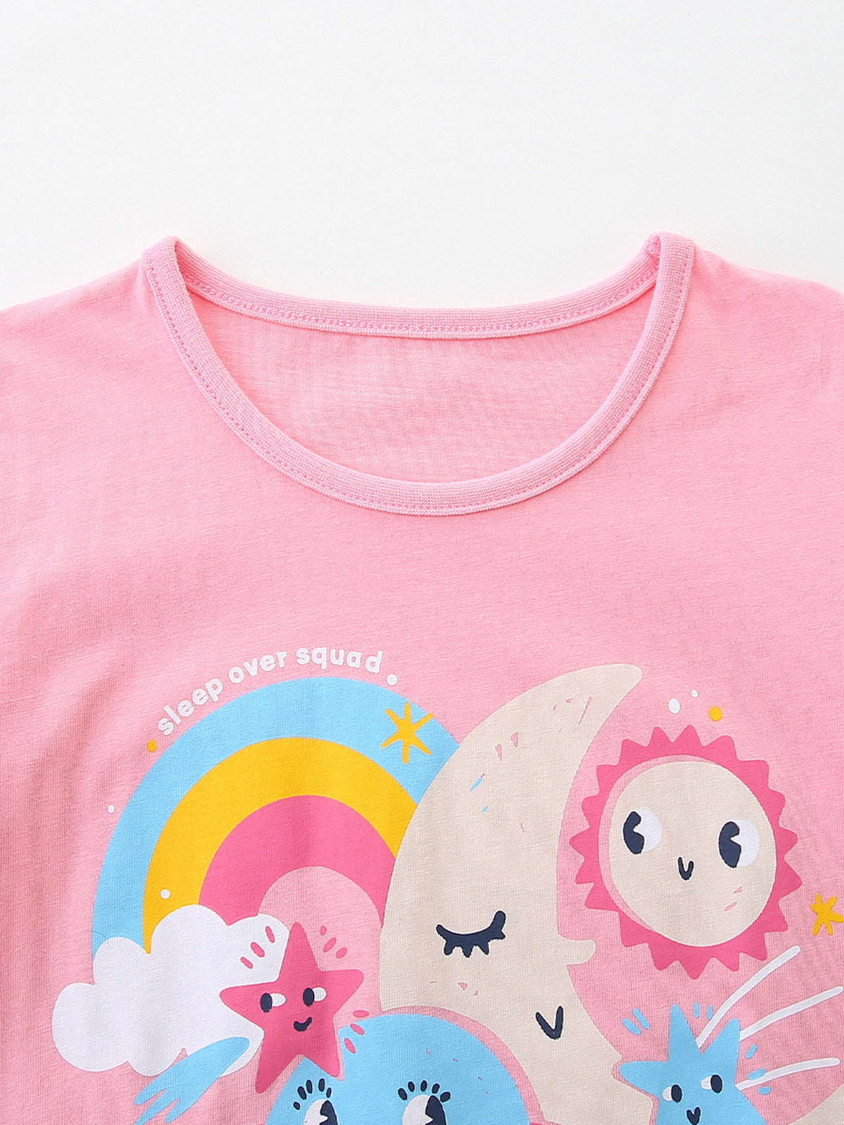 Pink cotton crew neck t-shirt with celestial graphic and "sleep over squad" text.