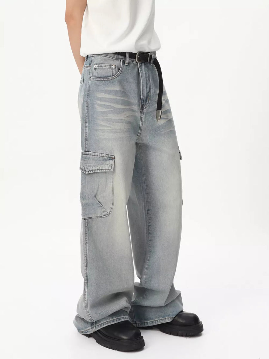 Relaxed fit light wash denim cargo jeans with vintage appeal and a black belt.