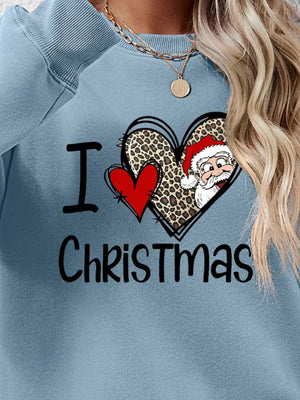 Light blue crewneck sweatshirt with festive heart graphic and Santa Claus detail.