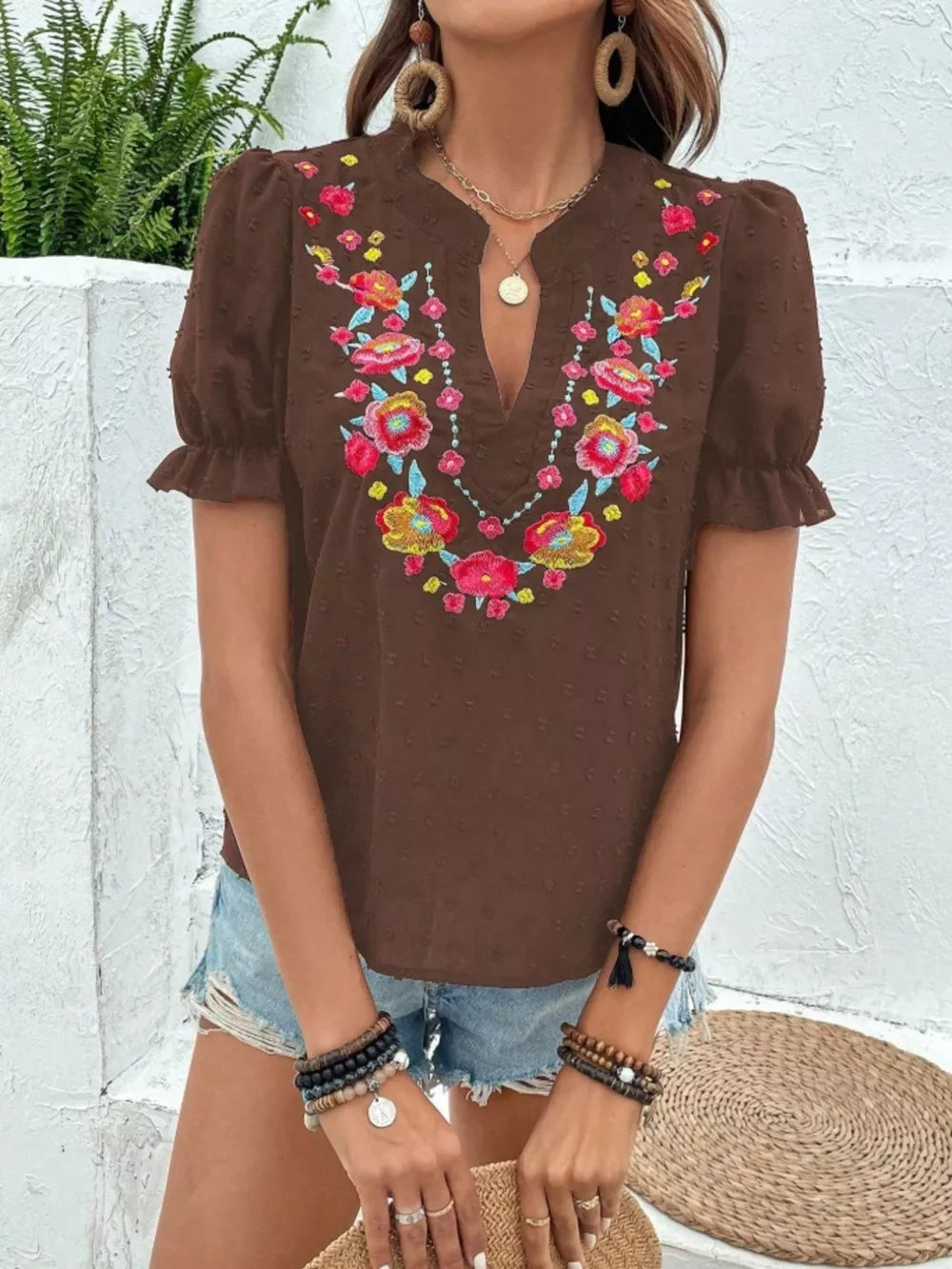 Brown embroidered puff sleeve blouse with floral neckline detail and v-neck.