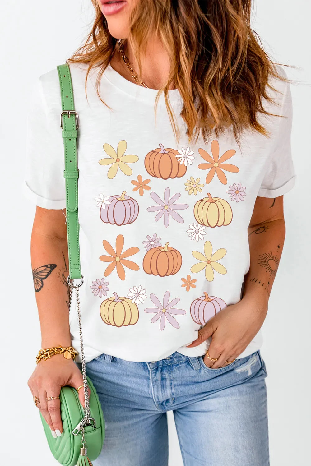 White t-shirt with a groovy pumpkin and flower graphic print.
