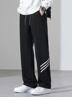 Black sweatpants with white side stripes and a drawstring waist.
