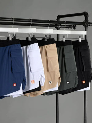 Performance layered cargo shorts in tan, white, royal blue, sage, and black with a black waistband.