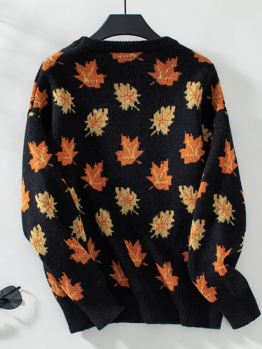 Black knit jumper with orange and yellow autumnal leaf pattern, crew neck, long sleeves.