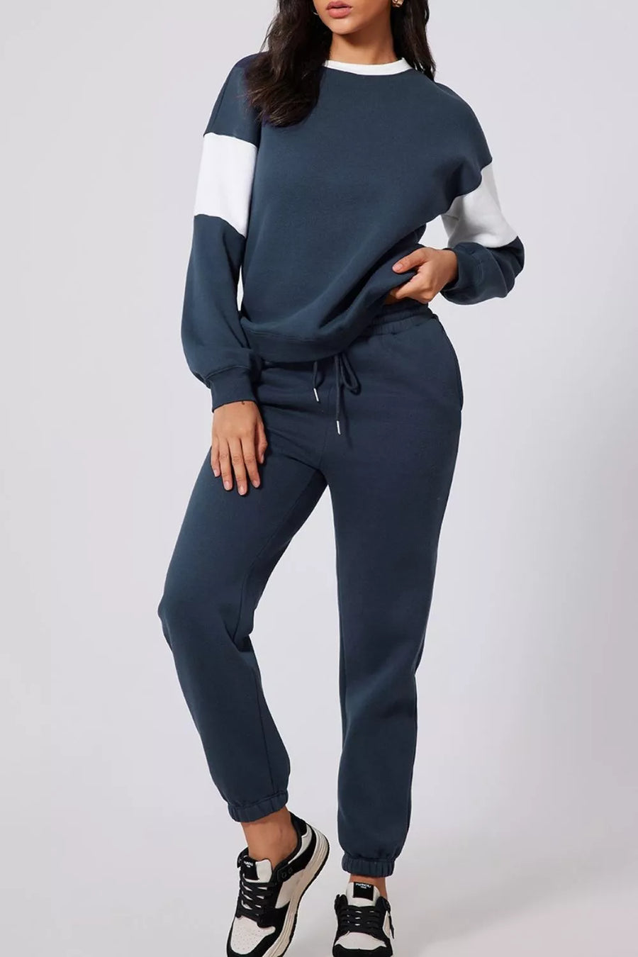Navy activewear set with contrast white sleeves and drawstring sweatpants