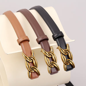 Elegant cowhide leather belts in caramel, brown, and black with gold chain buckle detail.