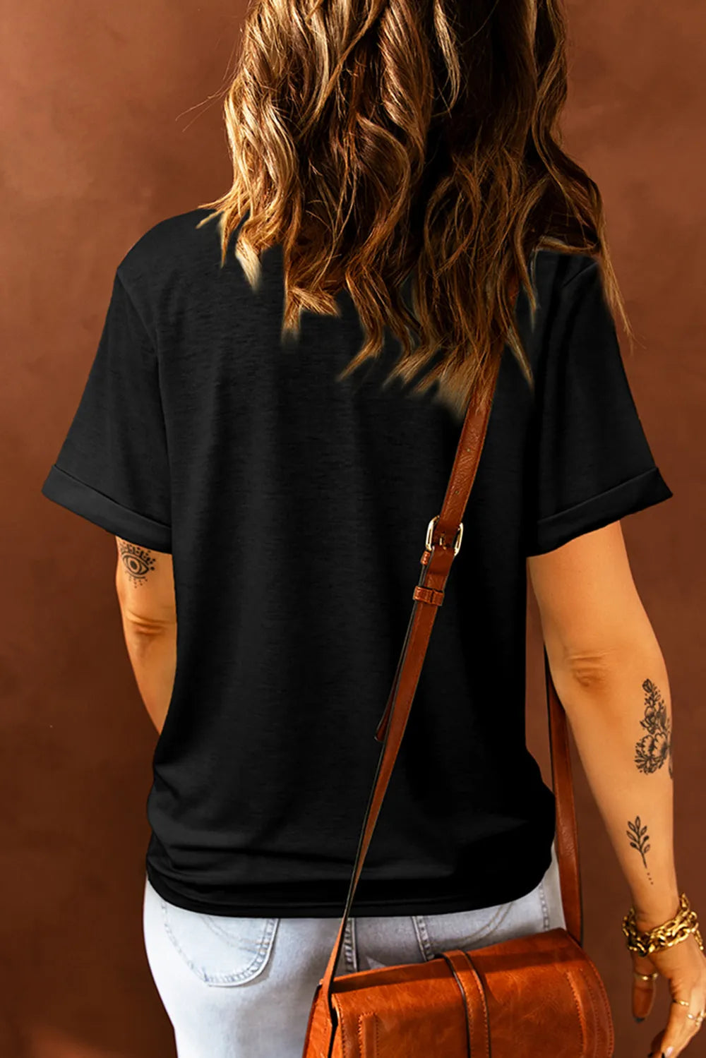 Black crew neck t-shirt with cuffed short sleeves and a painted heart graphic.