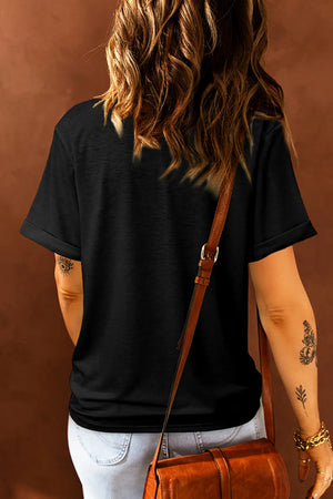 Black crew neck t-shirt with cuffed short sleeves and a painted heart graphic.
