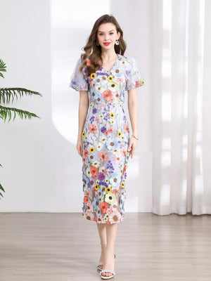 Sheath dress with V-neck, puff sleeves, and a colorful floral embroidery pattern.