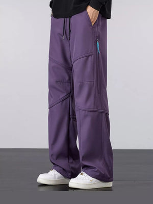 Men's purple loose fit cargo pants with drawstring and zippered pockets.