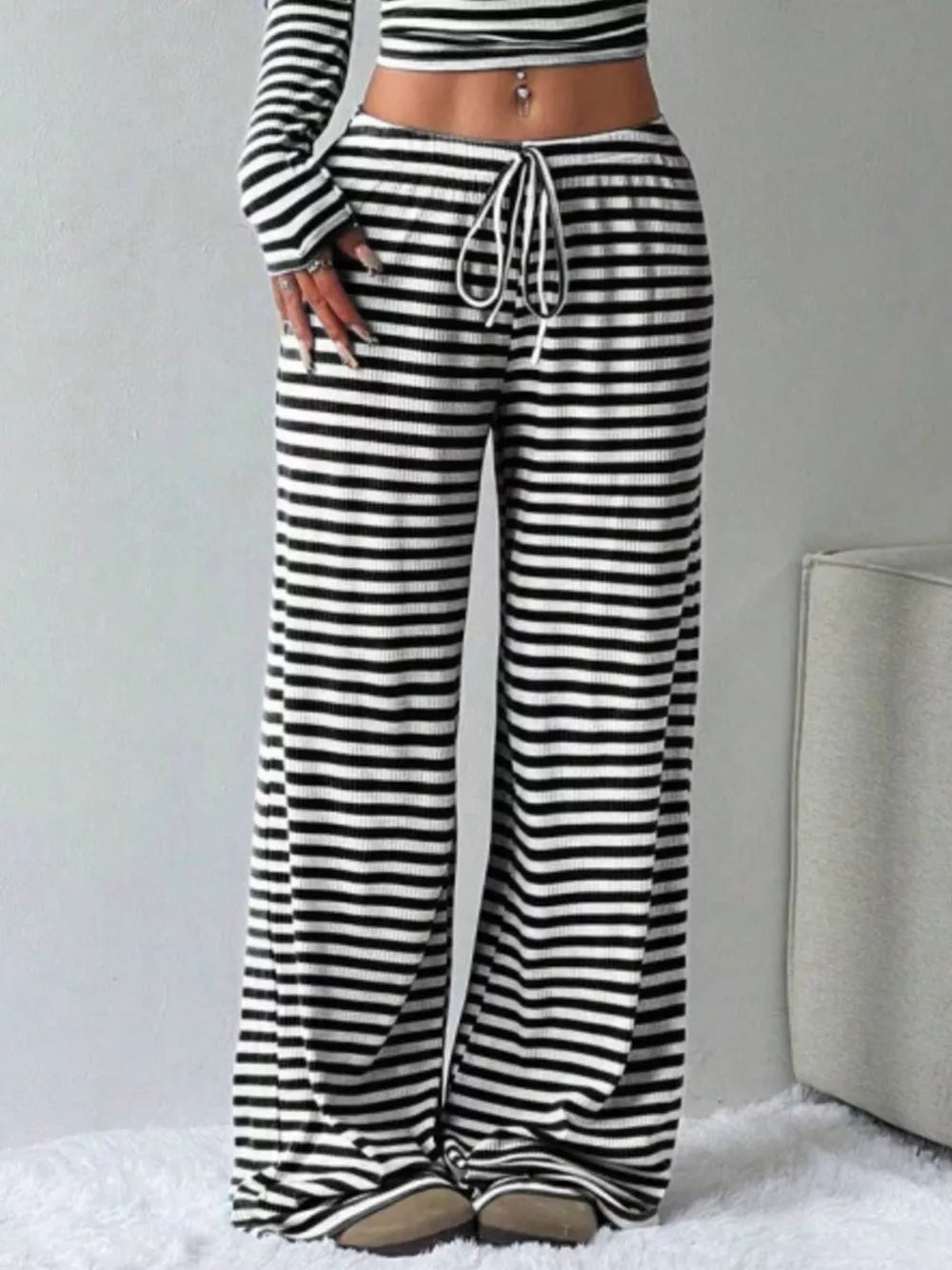 Black and white striped crop top and wide-leg pants with drawstring waist.