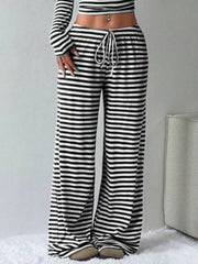 Black and white striped crop top and wide-leg pants with drawstring waist.