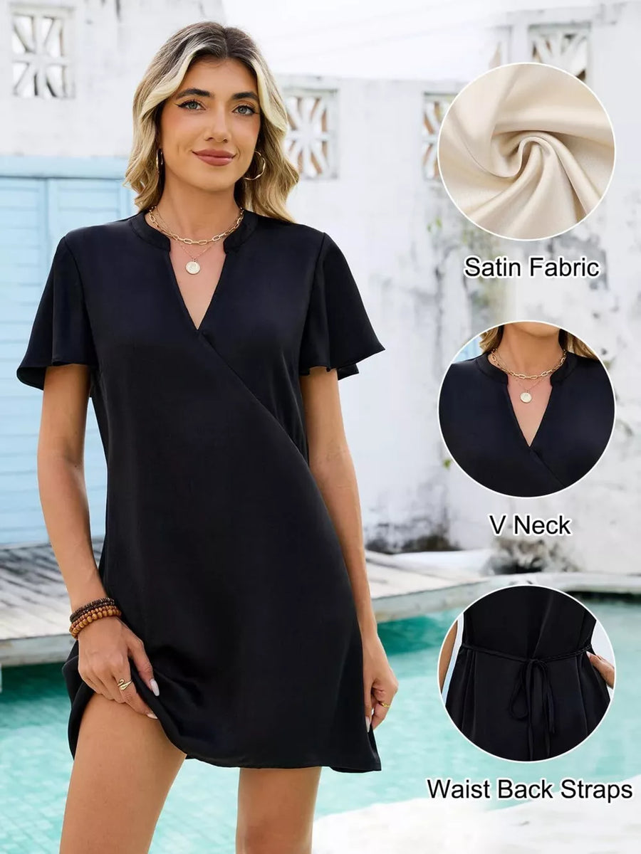 Black satin mini dress with V neck, flutter sleeves, and waist tie detail.