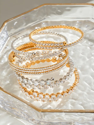 Gold and silver double row pavé bangles with clear crystals