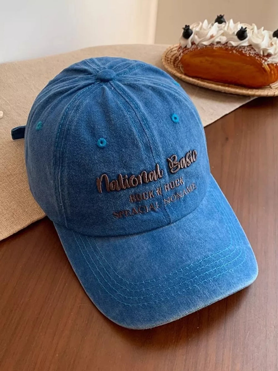 Blue washed baseball cap with embroidered text detail