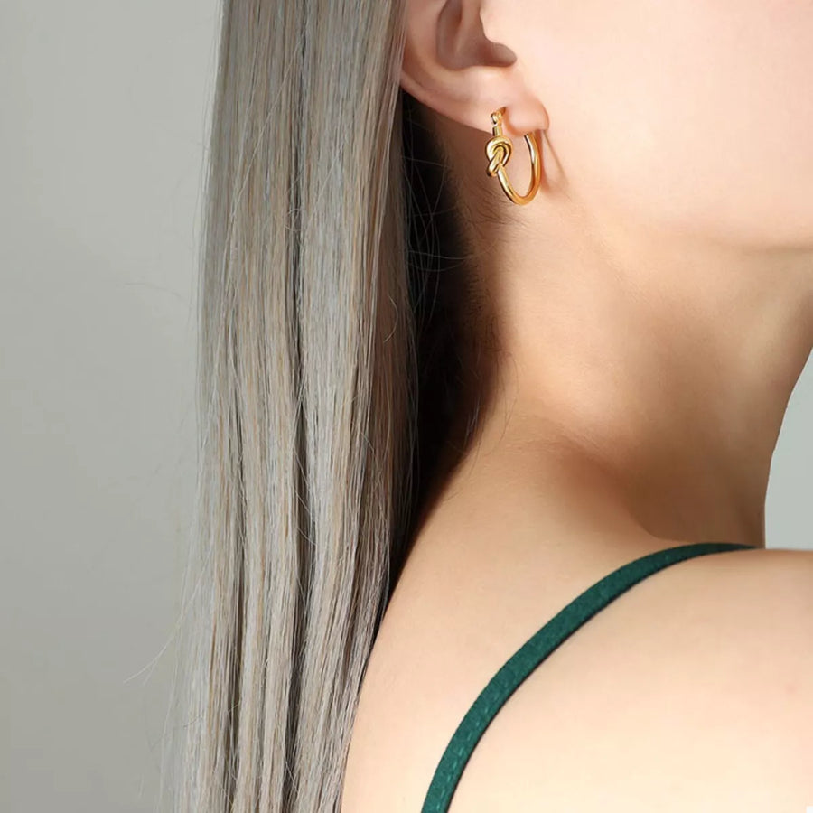 Gold knot hoop earrings, 18K gold-plated, elegant design.