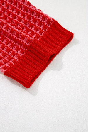 Red acrylic knit sweater with crochet detail and ribbed cuff.