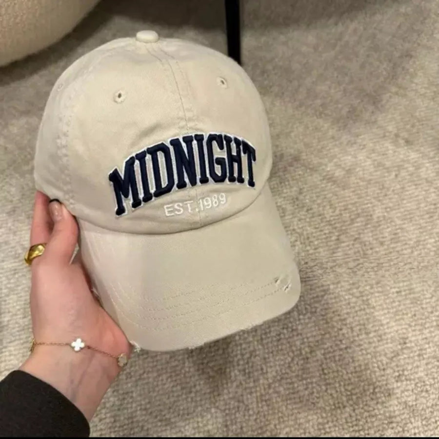 Cream white distressed baseball cap with navy blue "MIDNIGHT EST. 1989" embroidery