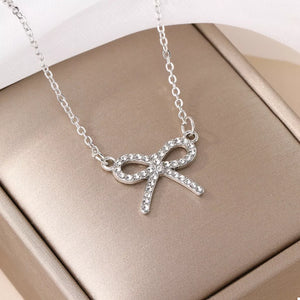 Silver bowknot pendant necklace with clear crystals on a delicate chain