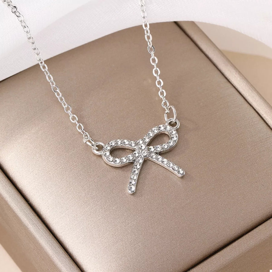 Silver bowknot pendant necklace with clear crystals on a delicate chain