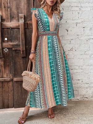 Bohemian maxi dress with ruffle sleeves, V-neck, and smocked waist in a colorful geometric print.