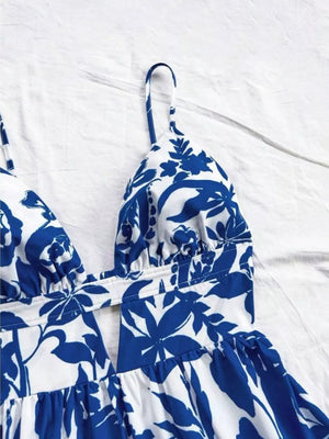 Vibrant floral mini dress with V-neck and cutout detail, blue and white pattern.