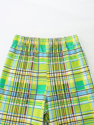 Baby shorts with green, yellow, blue, and brown plaid pattern and elastic waistband.