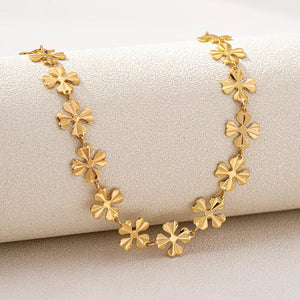 Gold necklace featuring 18K gold-plated and floral