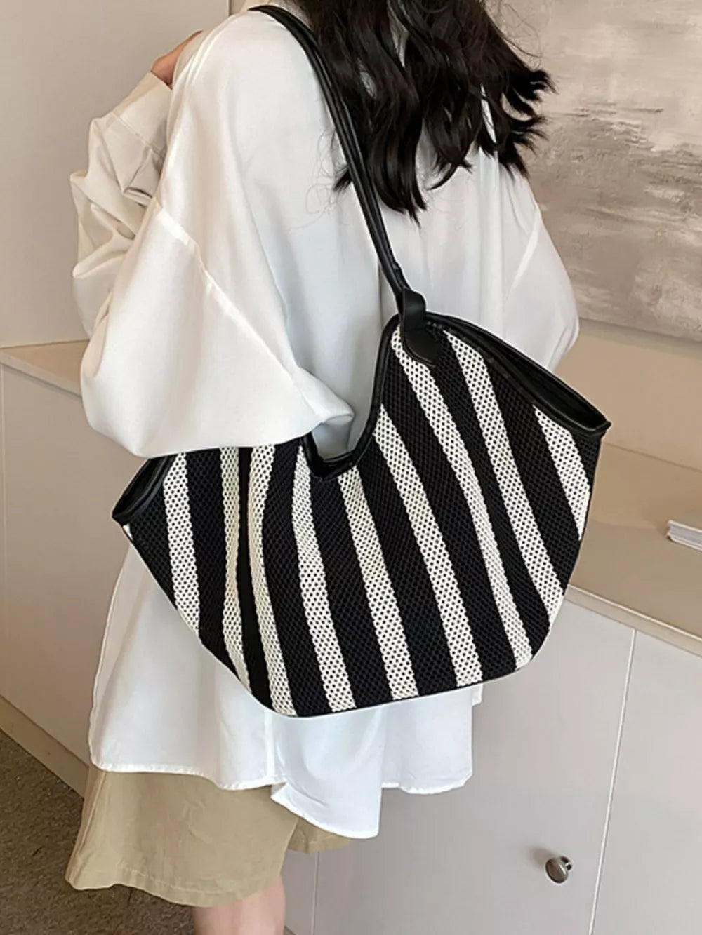 white handbag featuring knit texture and striped