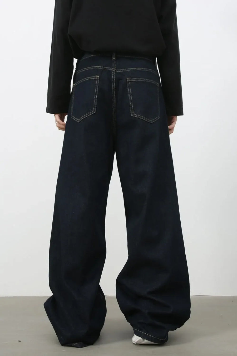 Dark denim exaggerated wide leg jeans with contrast stitching and back pockets.