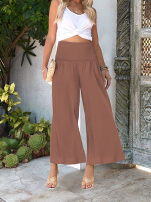 Light Brown smocked waist wide-leg trousers with textured fabric and ankle length.
