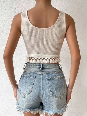 Cream textured tank top with playful tassel trim detail.