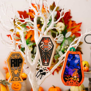 Spooky Silhouette Lantern Trio ornaments: RIP coffin, skull coffin, and pumpkin scene.