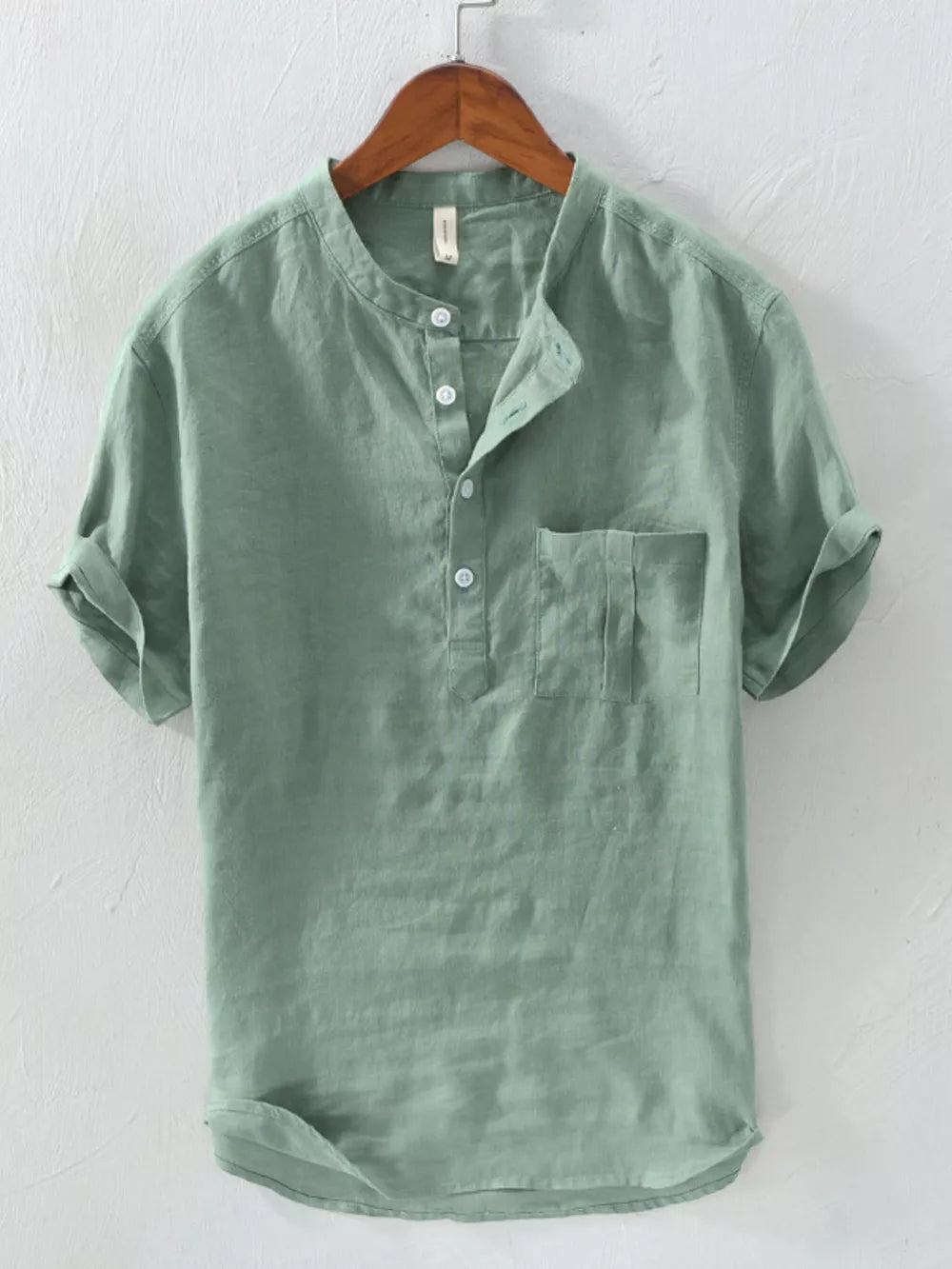 Green cotton blend band collar shirt with button detail and chest pocket.