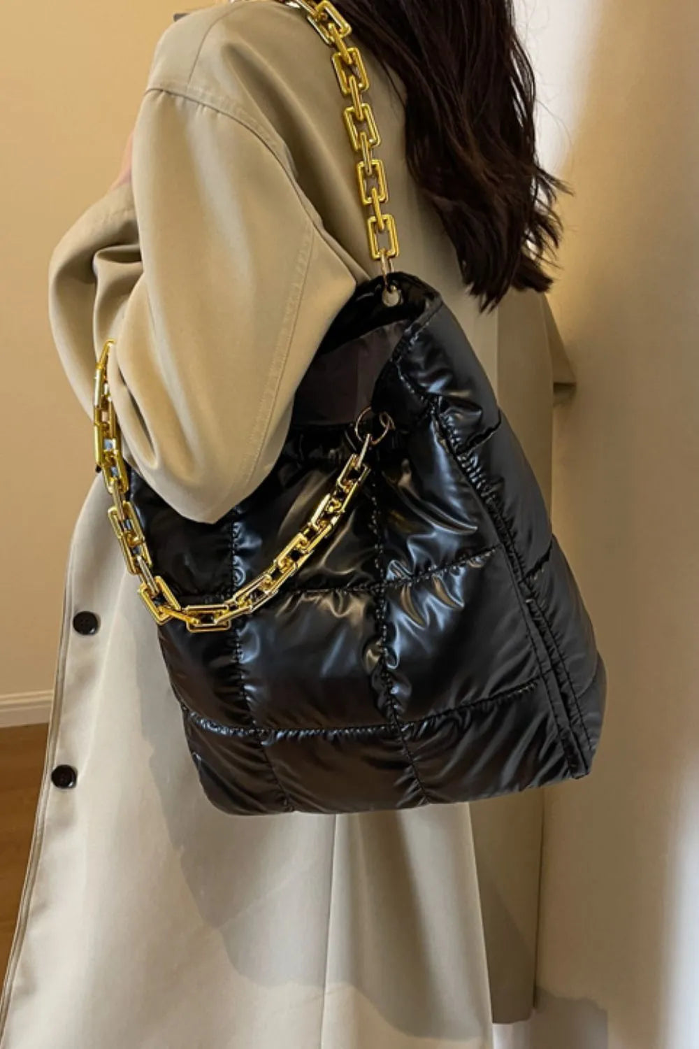 Black quilted nylon tote bag with gold chain strap detail