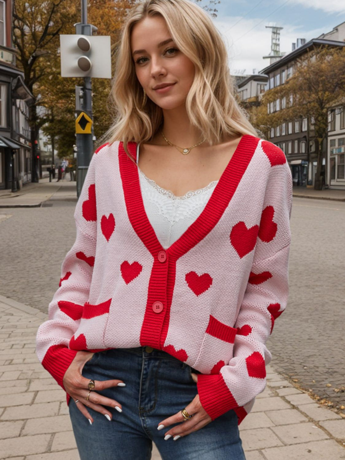 Love Letter Intarsia Knit Cardigan in pink with red hearts, v-neck, button front, and pockets.