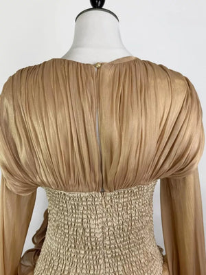 Gold ruffled mini dress with ruched corset waist and long sleeves.