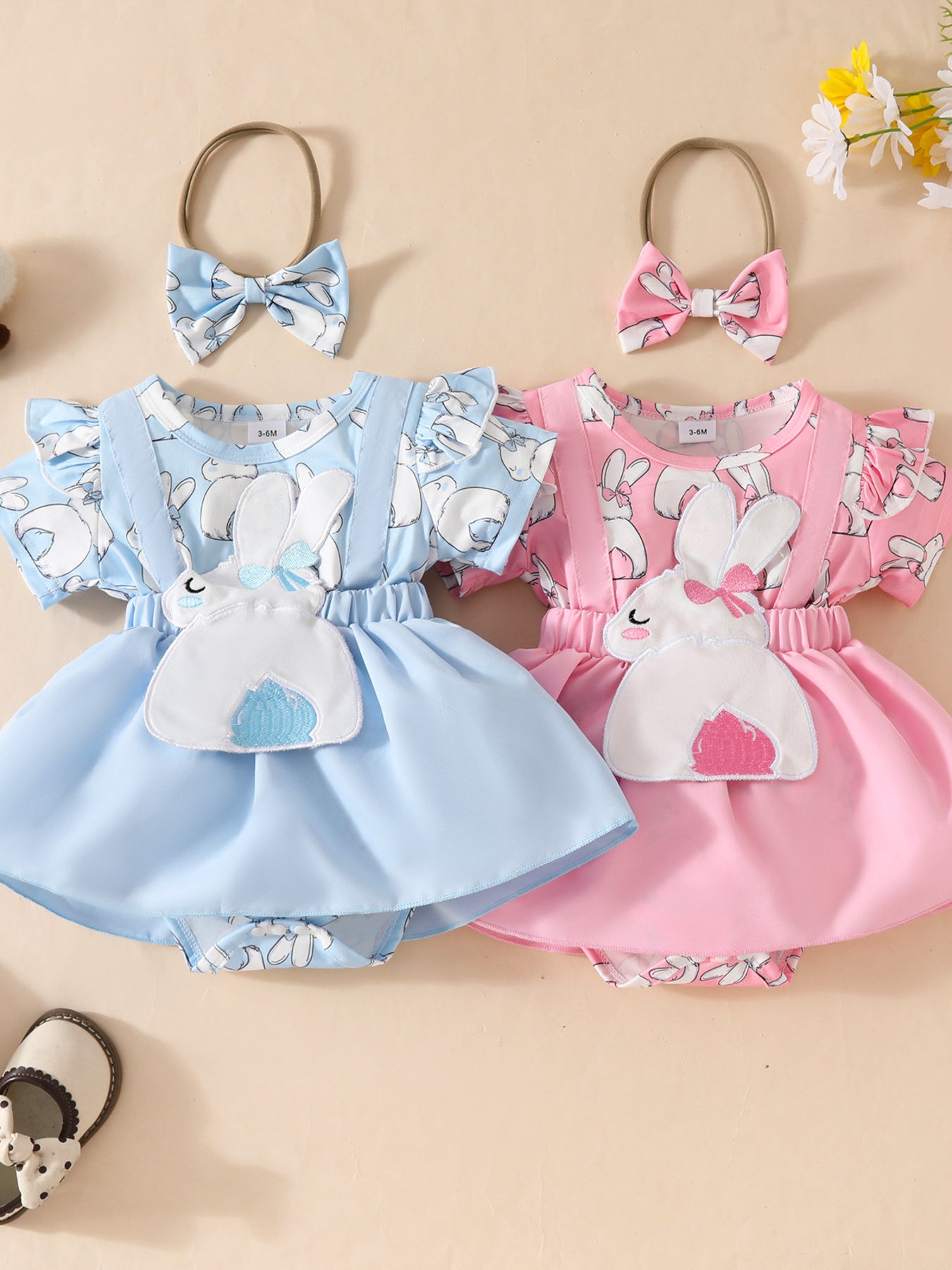 Baby girl dresses in sky blue and pink with bunny applique and bow headbands.