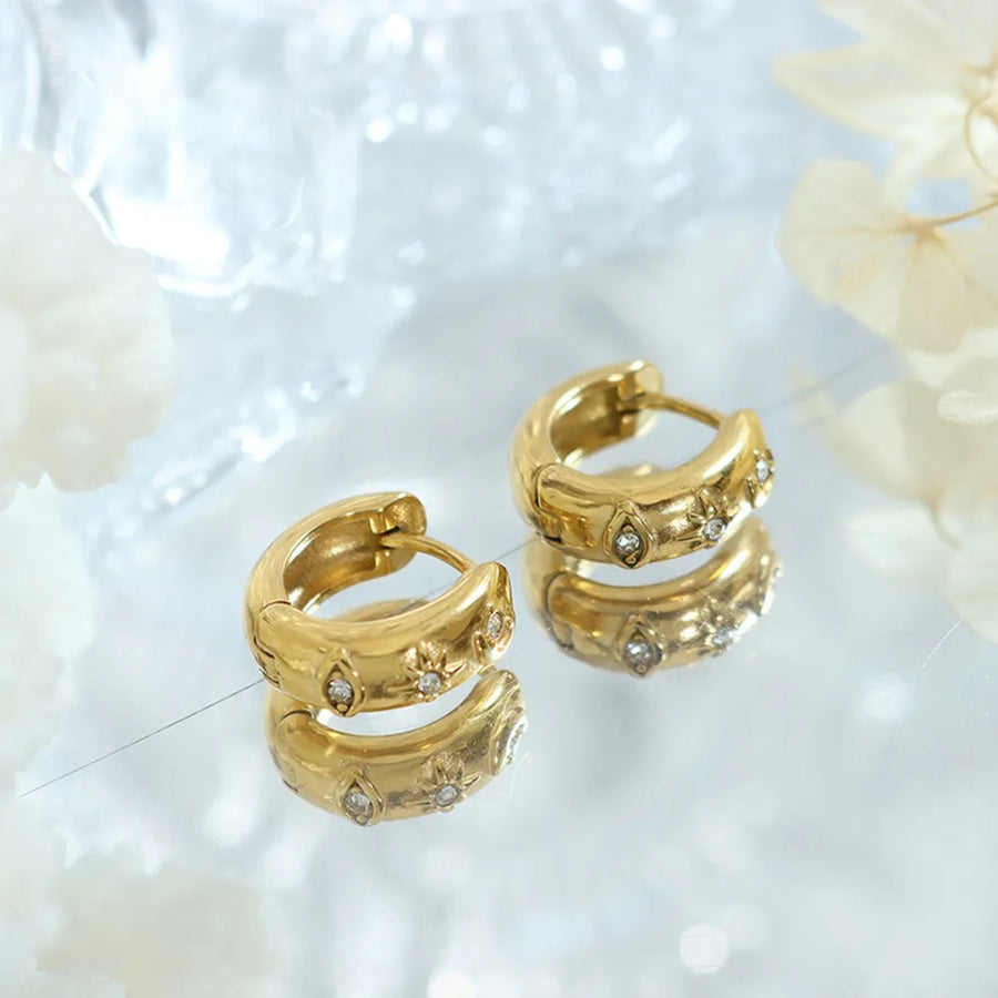 Gold zirconia-embellished mini huggie hoop earrings with star and diamond shapes.