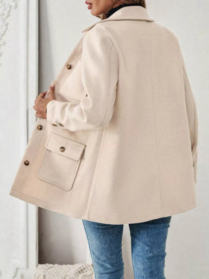 Apricot button-front trench coat with flap pockets and button details.