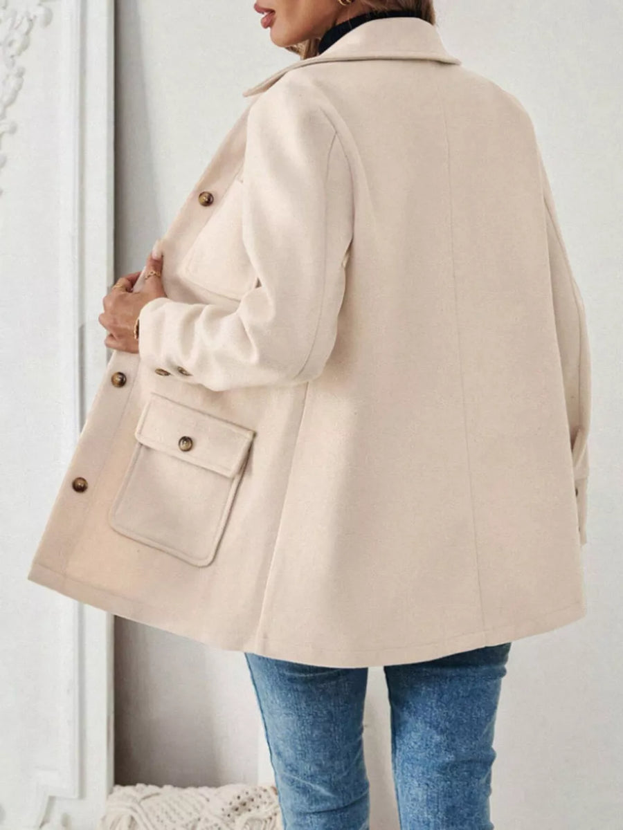 Apricot button-front trench coat with flap pockets and button details.