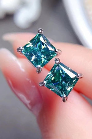 Emerald cut stud earrings in green with silver setting.