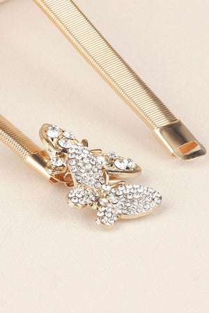 Gold elastic belt with a crystal-encrusted butterfly clasp.