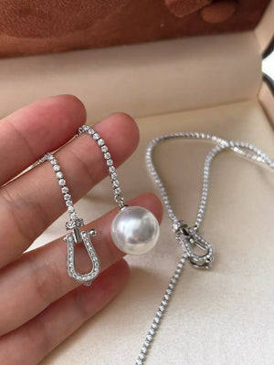 Lustrous pearl drop Y-necklace with diamond horseshoe clasp and chain