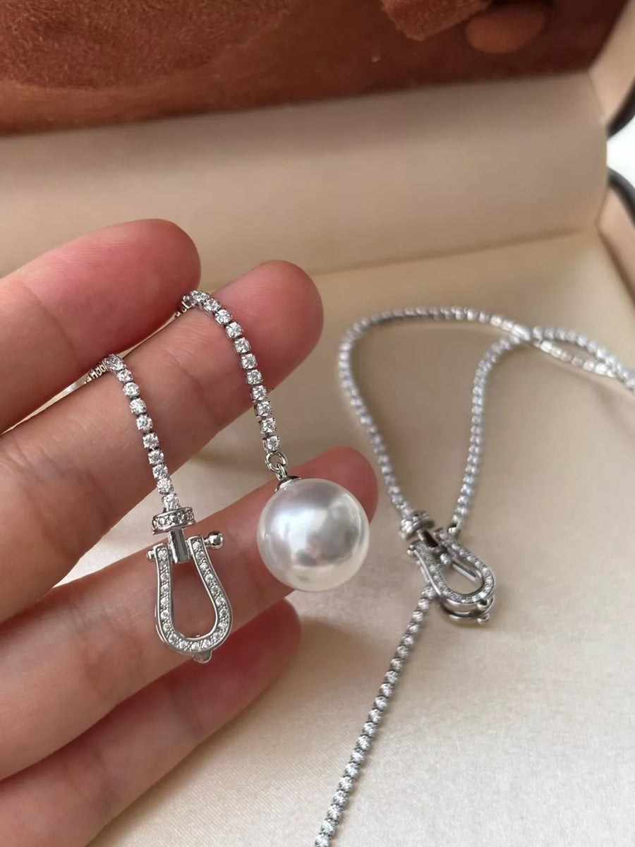 Lustrous pearl drop Y-necklace with diamond horseshoe clasp and chain