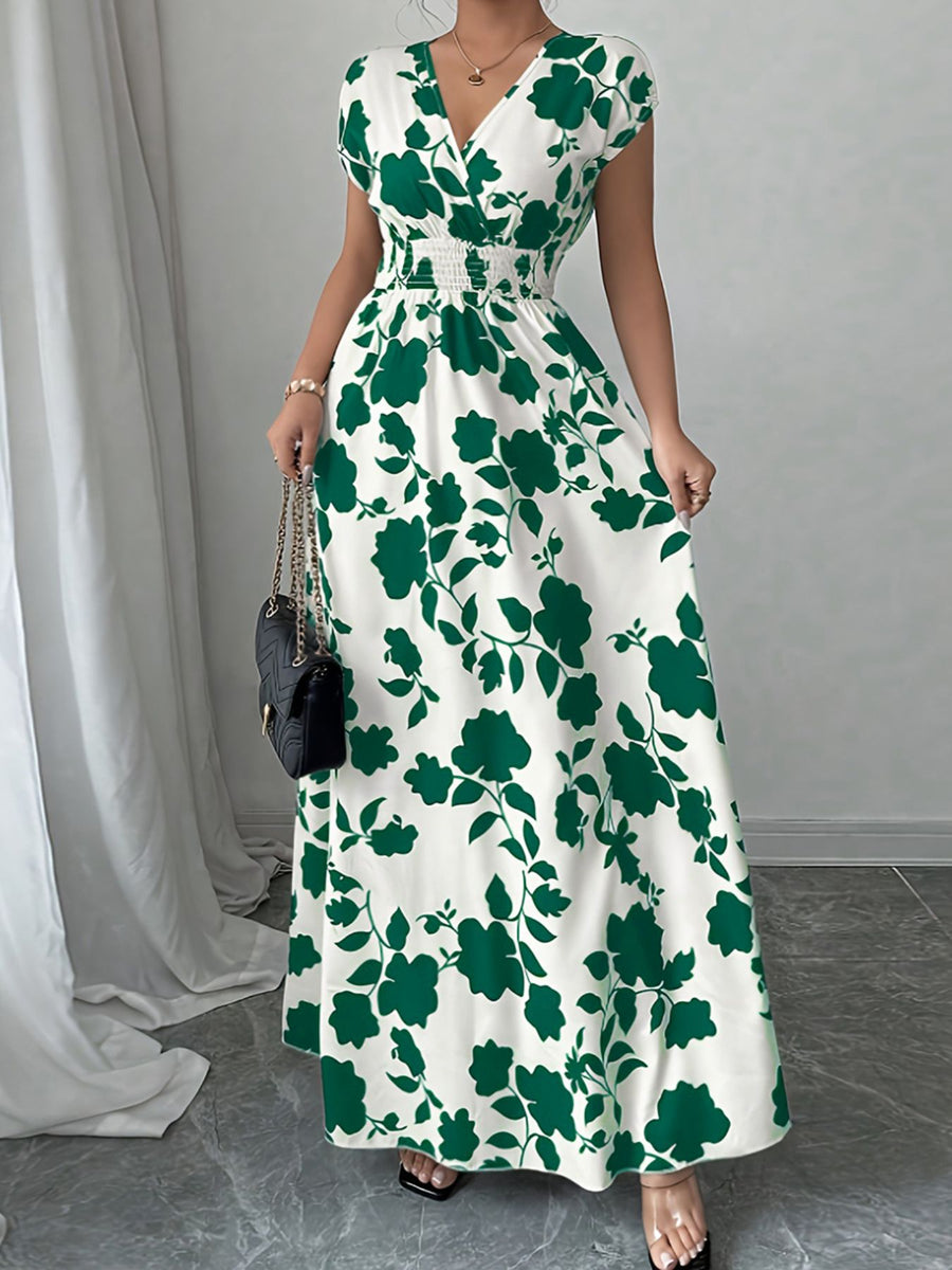 Floral surplice maxi dress in white with green floral print, cap sleeves, and smocked waist.
