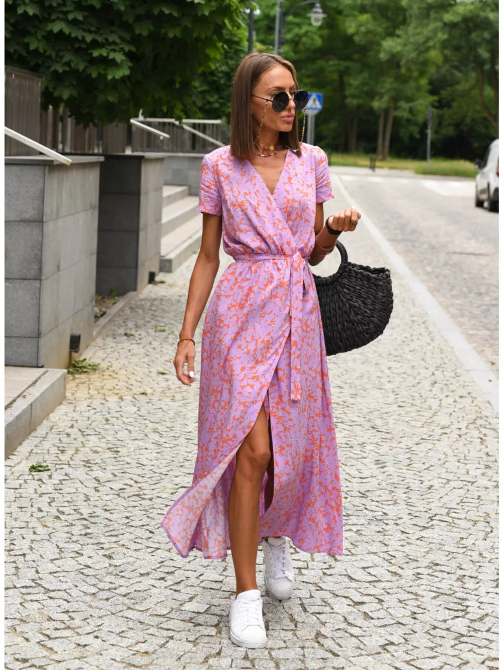 Wrap dress in lavender with an orange floral print, V-neck, short sleeves, and tie waist.