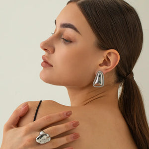 Sculpted silver vermeil earrings with textured trim and matching abstract ring.